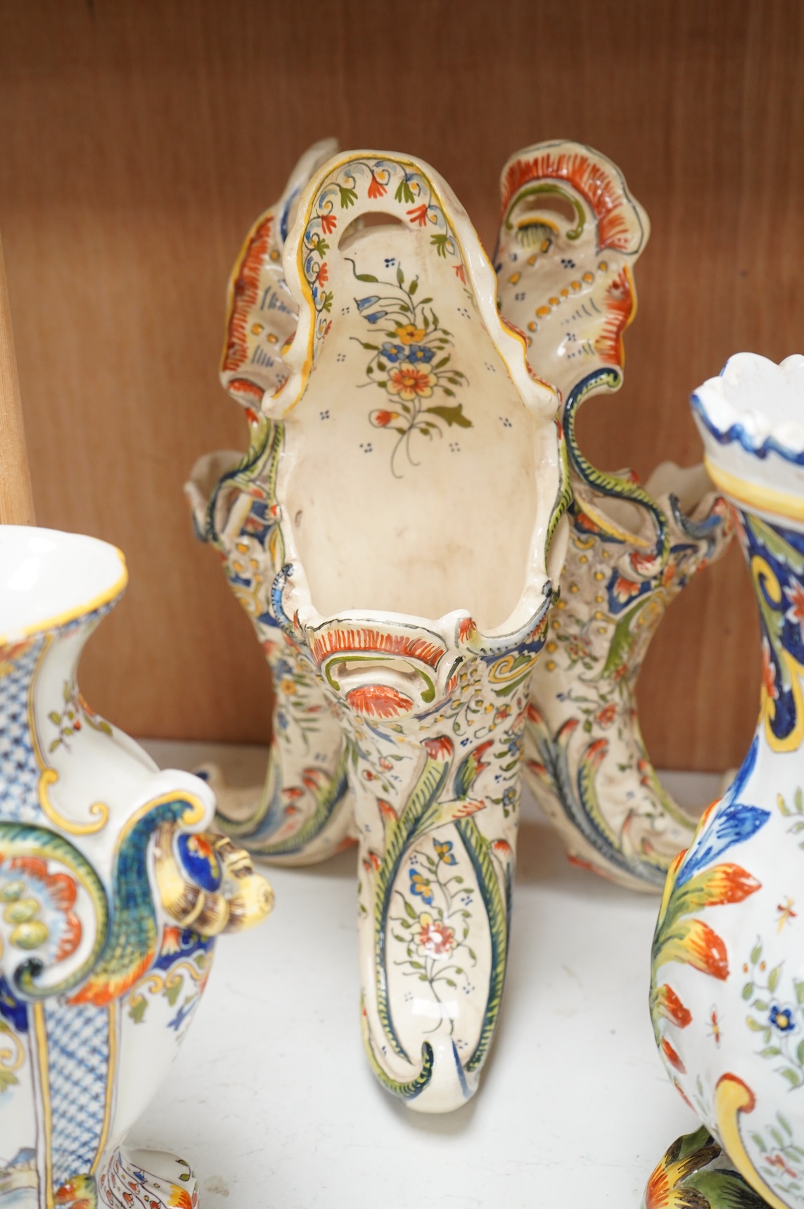 Two late 19th / early 29th century French faience vases and two similar centrepieces, largest 35cm high